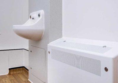 Clinical sink and white radiator cover.