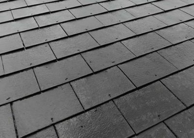 Dark grey slate roof tiles.
