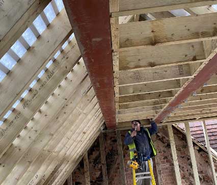 roof-installation Worker installing roof.