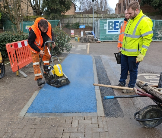Construction workers installing a safety walkway.